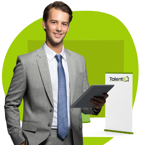 A smiling man in a gray suit holding a tablet, standing next to a banner displaying the TalentIQ logo, against a bright green background.